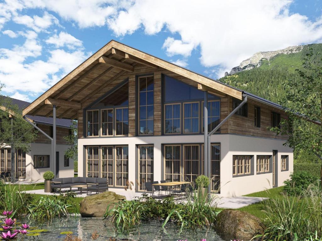 a rendering of a house with mountains in the background at Cosy, new chalet with garden and private sauna in Bichlbach