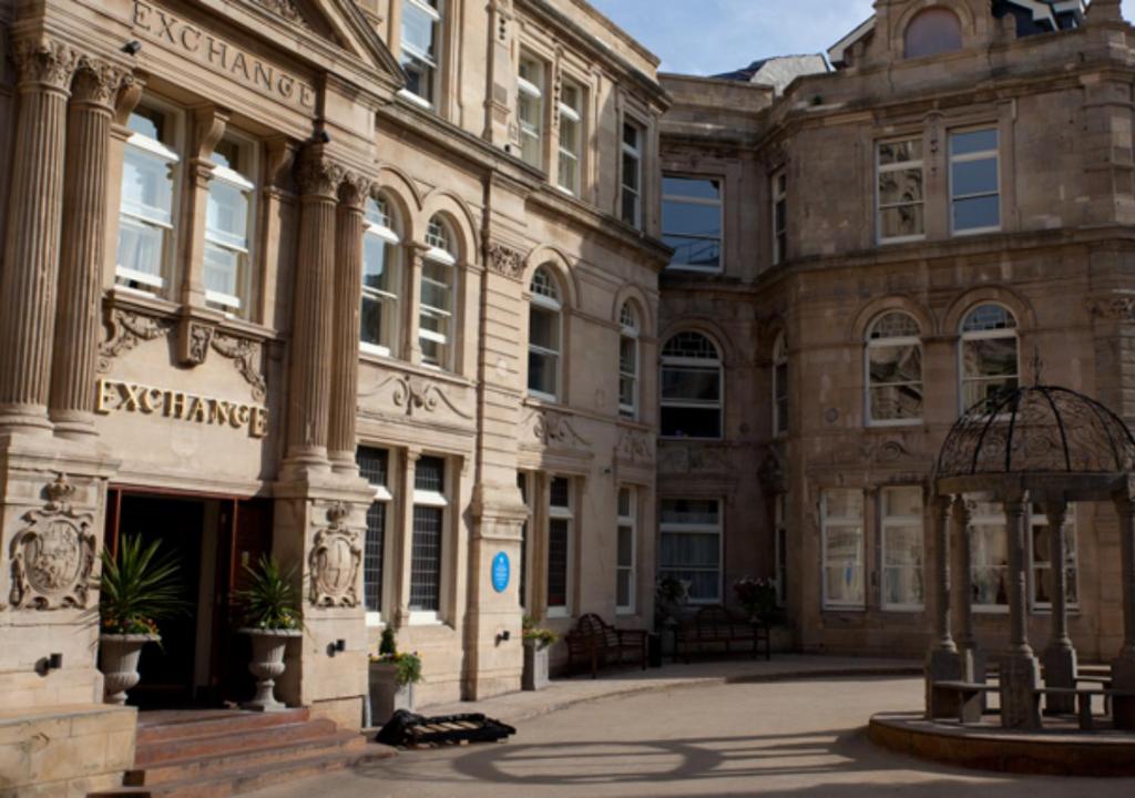 a large building with an entrance in a courtyard at The Coal Exchange Hotel in Cardiff