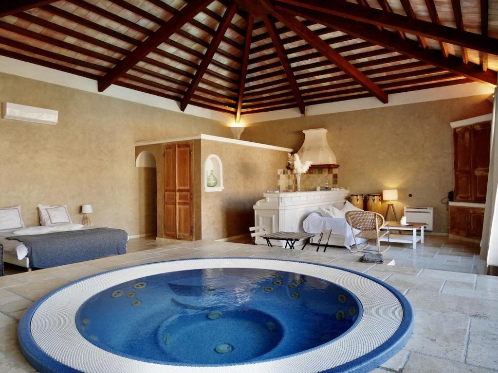 a large tub in the middle of a room at Le Pool House - Private Jacuzzi - Mas des Sous Bois in Ventabren