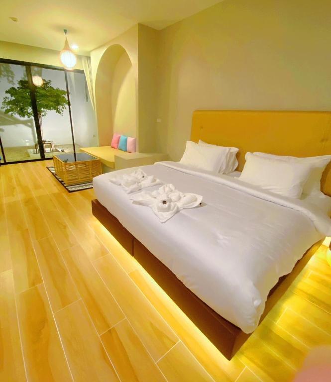 Postel nebo postele na pokoji v ubytování Chul Boutique Villa จุล บูทิค วิลล่า