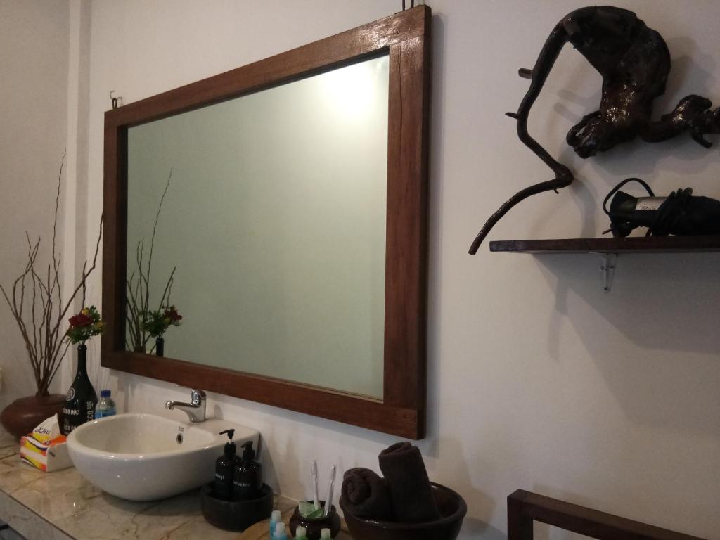 a bathroom with a large mirror and a sink at The luxe villas lombok in Kuta Lombok