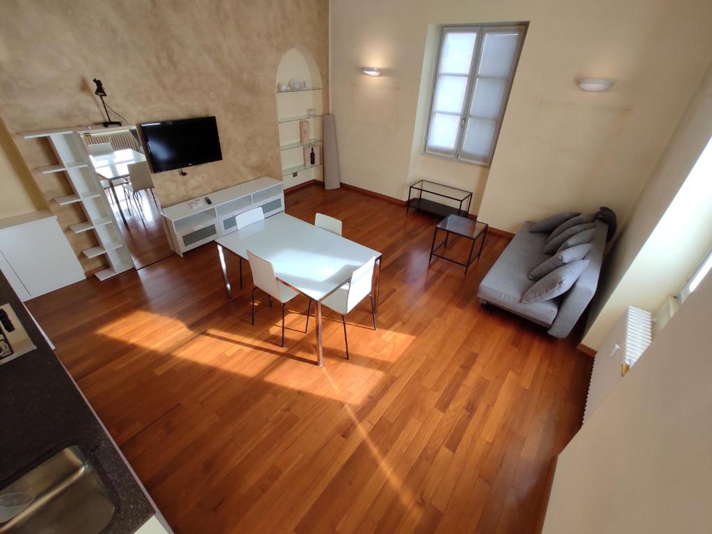a living room with a table and a couch at Solferino Apartment 2 in Turin