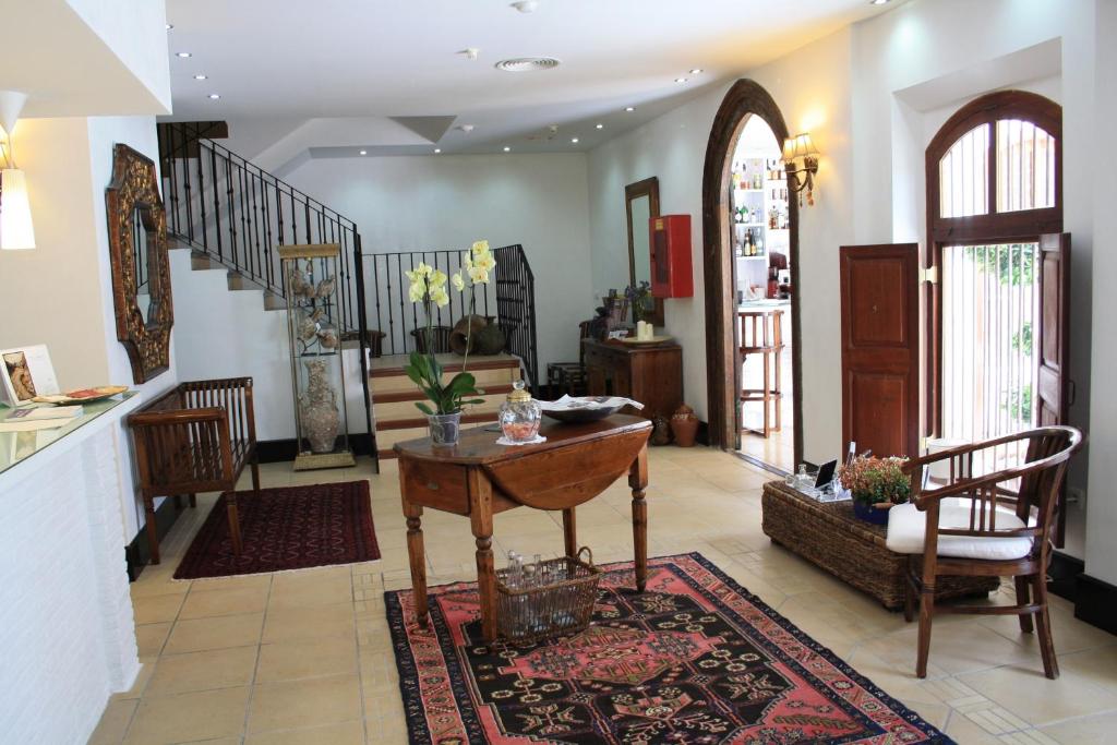 a living room with a table and a staircase at Santuario San José in San José