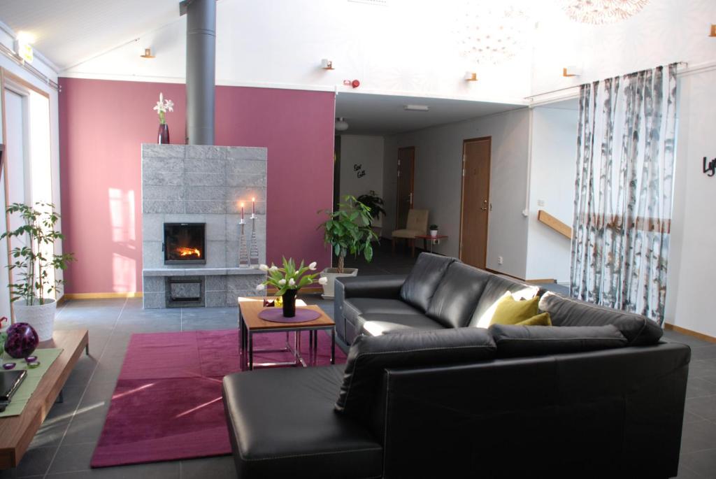 a living room with a couch and a fireplace at Rum För Resande in Skellefteå