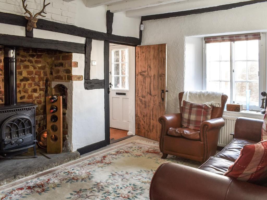 a living room with a couch and a fireplace at The Farm Cottage in Bognor Regis