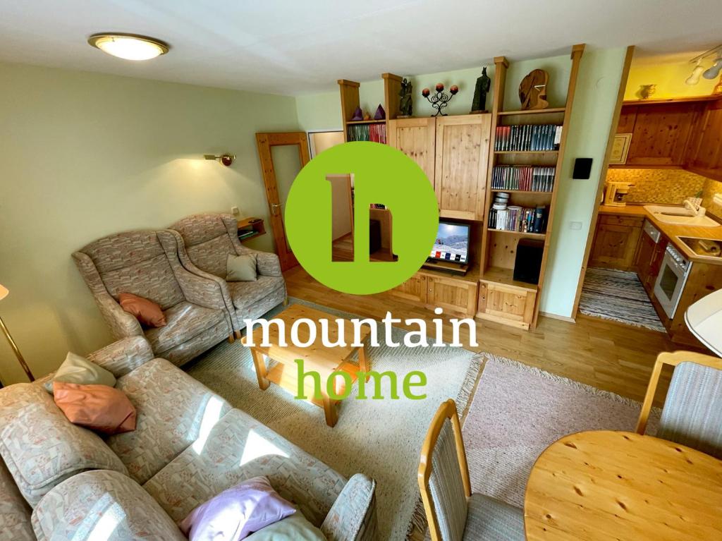 a living room with a couch and a dining room at The Mountain Home in Hermagor