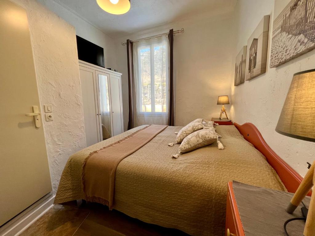 a bedroom with a bed with an animal on it at Les Merisiers B&B - Thorenc in Thorenc