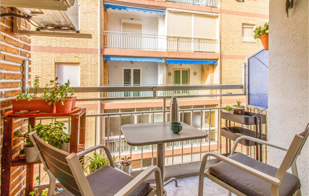 a balcony with a table and chairs and a building at Beautiful Apartment In Santa Pola in Santa Pola