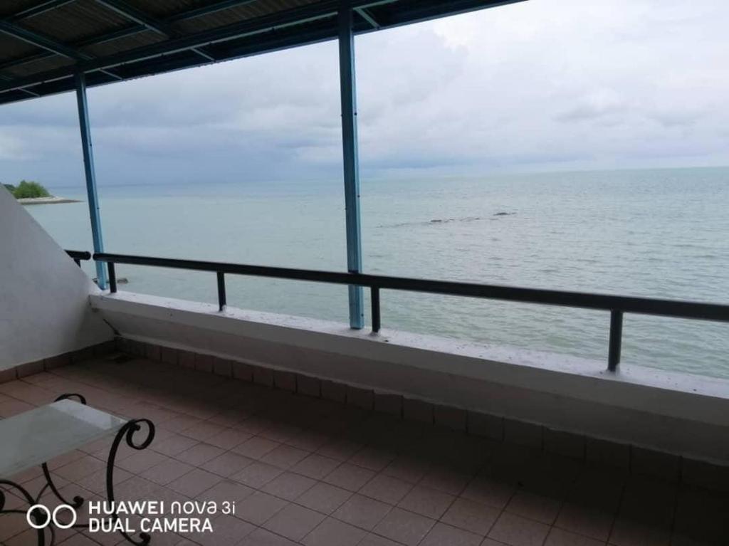 a balcony with a view of the ocean at Putri homestay Seaview pd in Port Dickson
