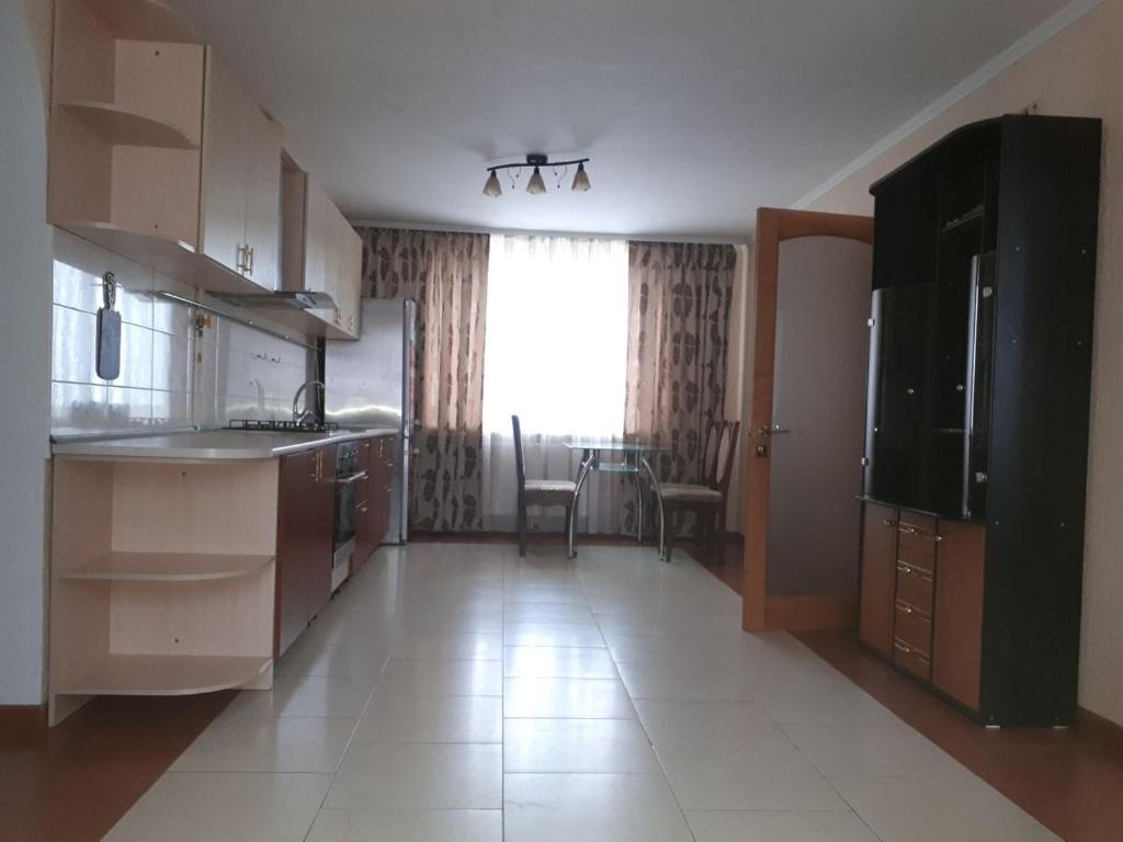 a kitchen with a sink and a large window at Апартаменти 100 кв.м на Шота Руставелі in Odesa