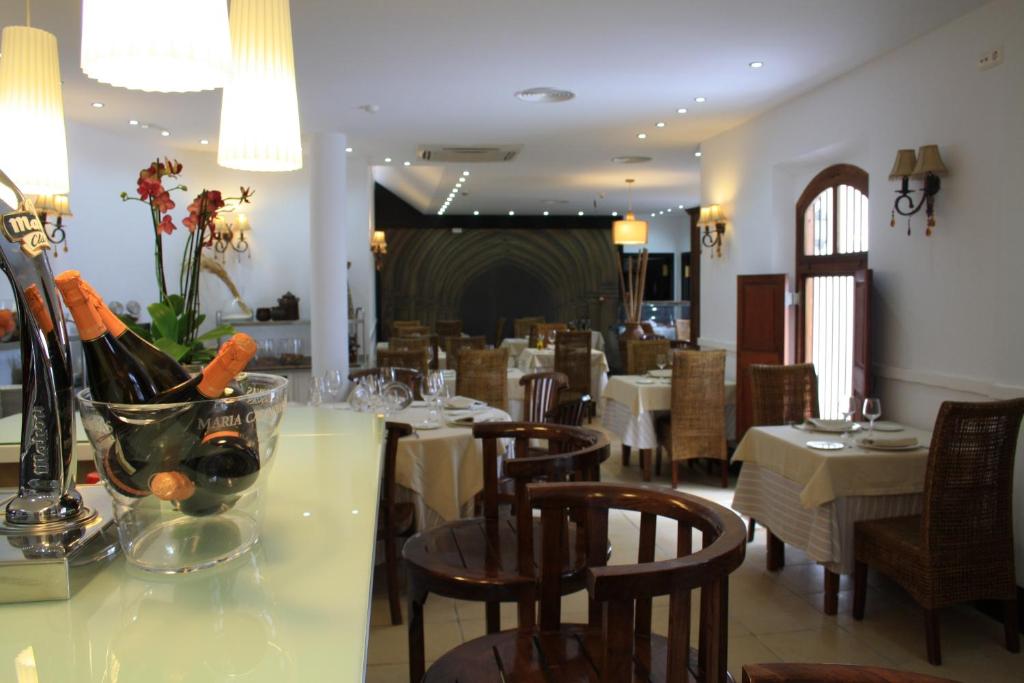 a dining room with tables and chairs with wine bottles at Santuario San José in San José
