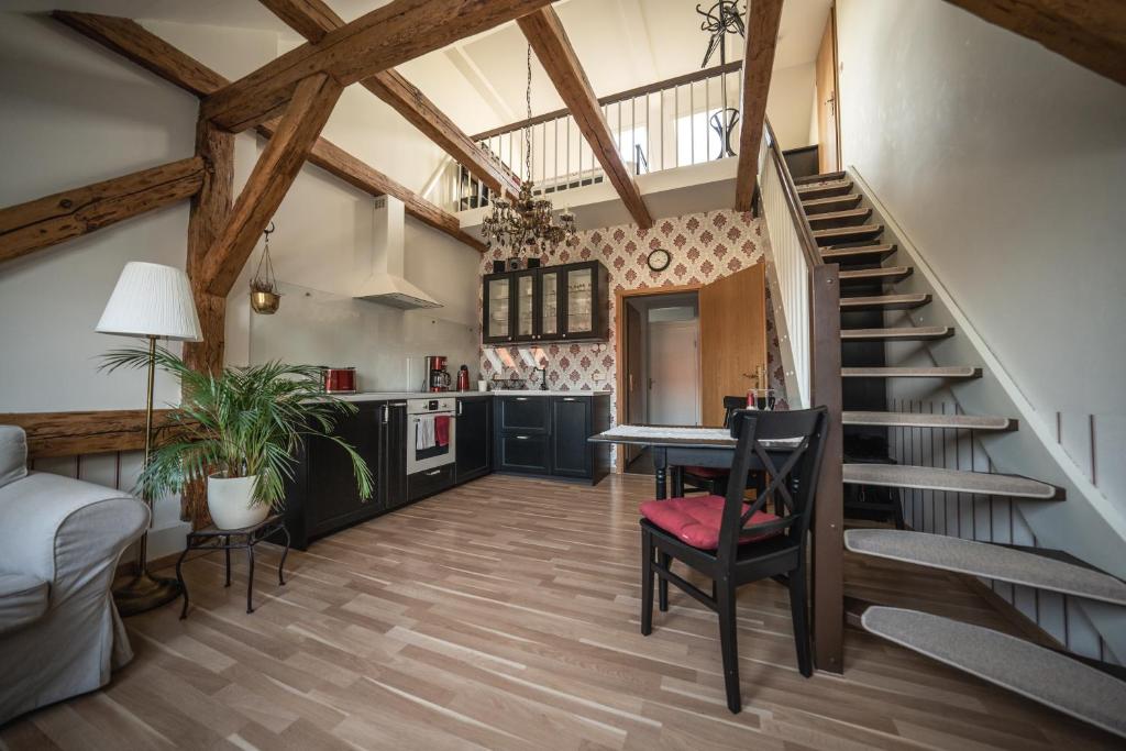 a kitchen and living room with a staircase and a table at Ferienwohnung Josephine in Vetschau