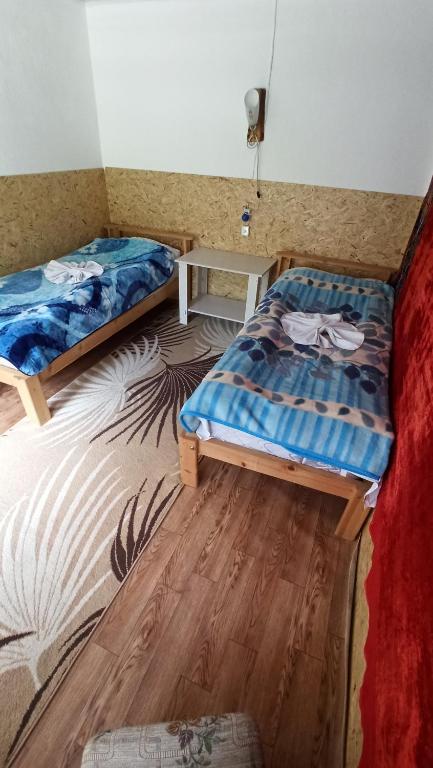 Postel nebo postele na pokoji v ubytování Guest House Jekshen