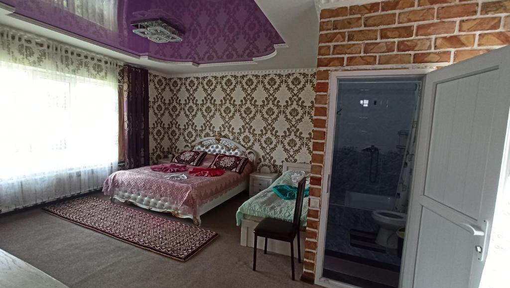 Postel nebo postele na pokoji v ubytování Guest House Jekshen