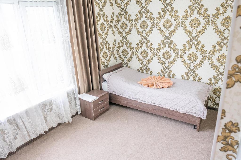 Postel nebo postele na pokoji v ubytování Guest House Jekshen