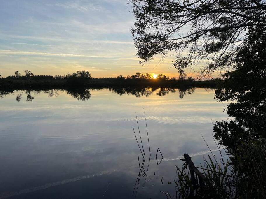 a view of a lake with the sunset in the background at Beautiful Waterfront 1 bedroom #4 in Punta Gorda