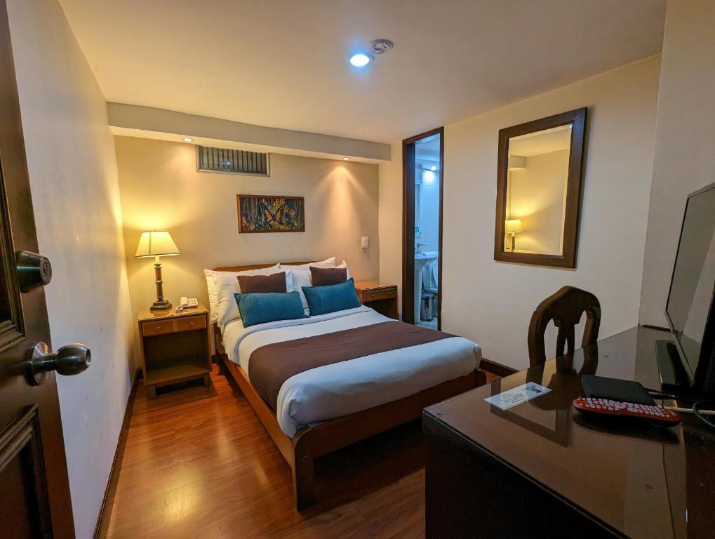 Postel nebo postele na pokoji v ubytování Hotel La Sabana