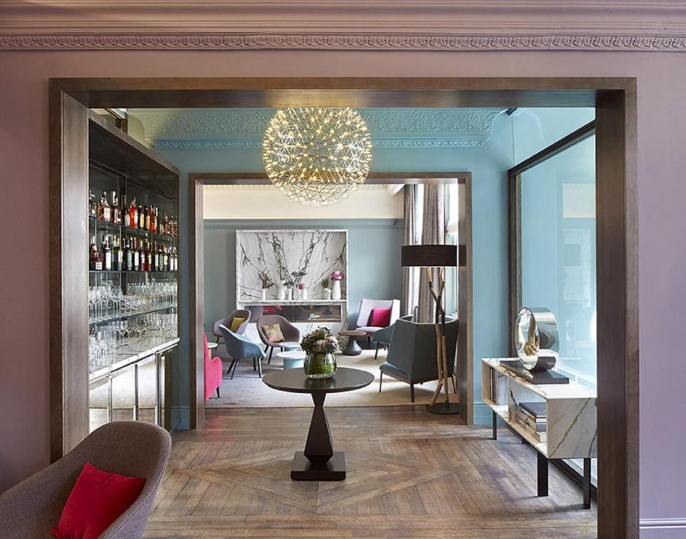 a living room filled with furniture next to a window at Signature Townhouse London Hyde Park in London