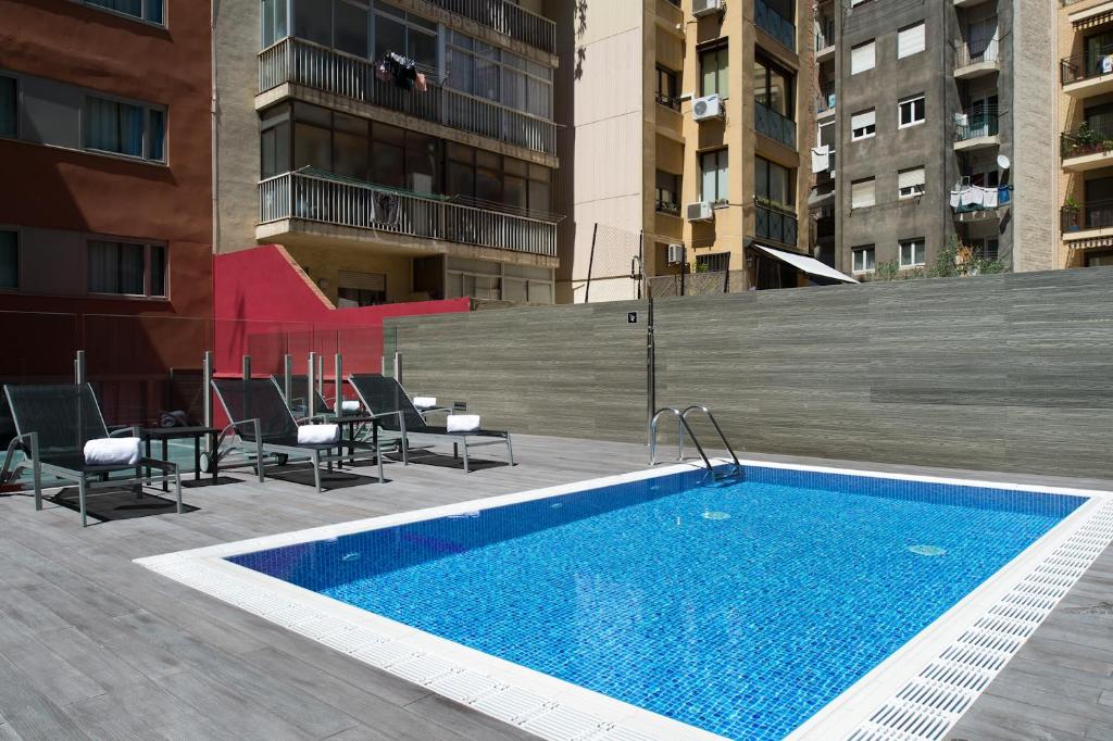 a swimming pool on the roof of a building at Catalonia Sagrada Familia in Barcelona