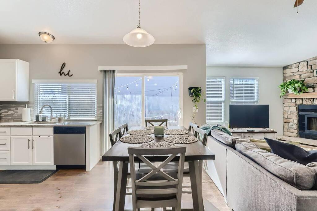 cocina y sala de estar con mesa y sofá en Sunnyside Up - Beautiful Home for Large Ski Groups, en Aurora