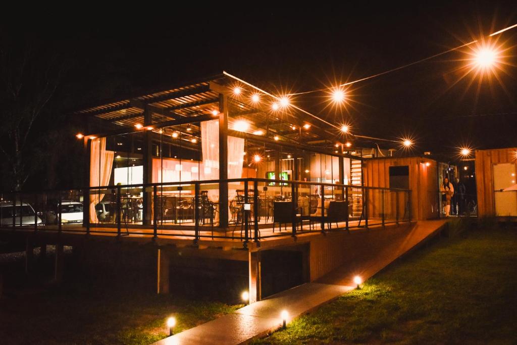 a building with a deck at night with lights at Pousada Container e Spa Mina Beer in Ametista do Sul