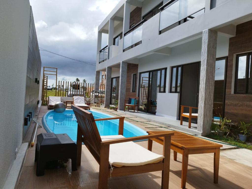 a swimming pool in the middle of a house at Bless in Maragogi