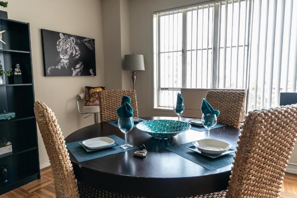 a dining room with a black table and chairs at Spacious Charming Condo with Great Views near the Grove in Los Angeles