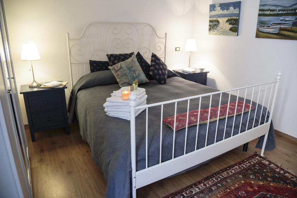 a bedroom with a white bed and two night stands at La Dimora Di Odisseo in Trapani