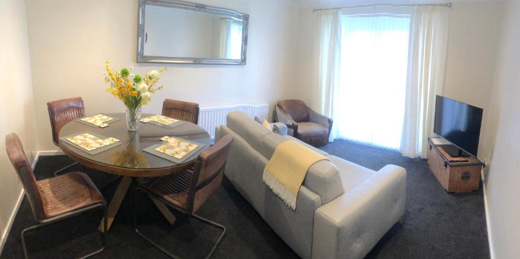 a living room with a couch and a table at Highthel Holiday Home by the Northumberland Coast in Morpeth