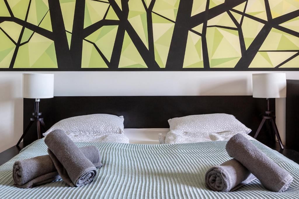 A bed or beds in a room at Art Downtown Home styled by a Local Designer