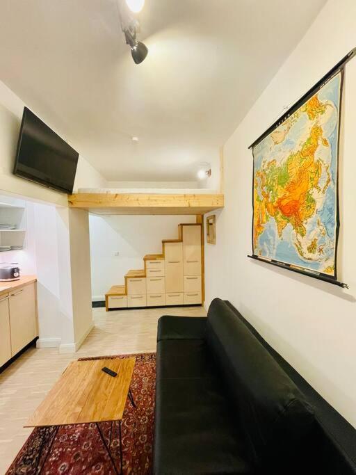 a living room with a couch and a map on the wall at Exklusives Apartment nahe VW-Halle in Braunschweig