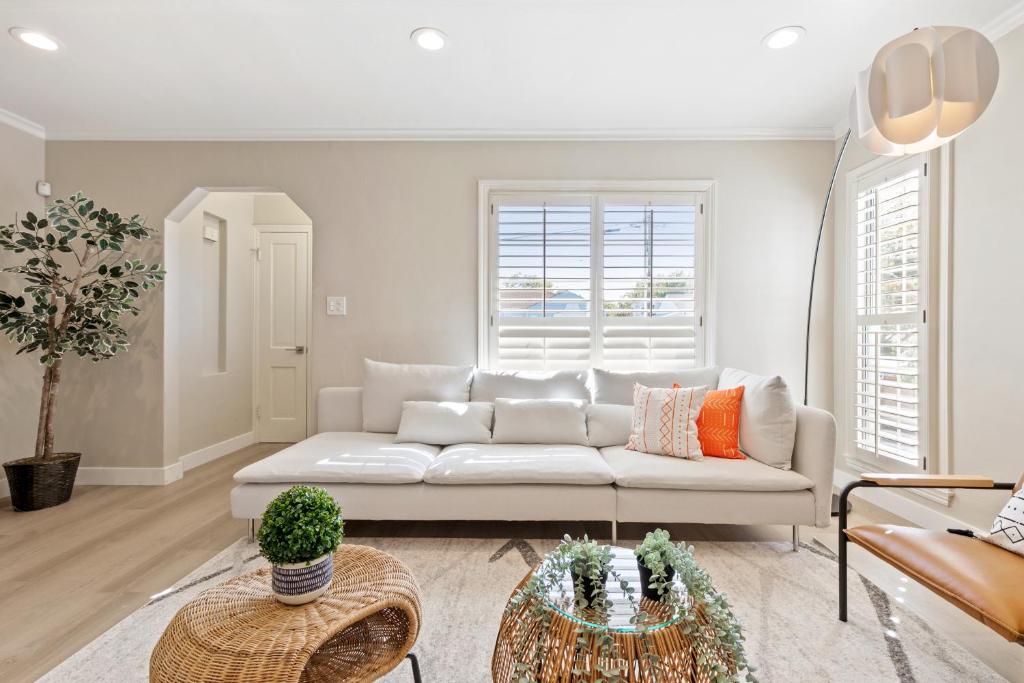a living room with a white couch and a table at @ Marbella Lane - Modern Refreshing Home in San Mateo