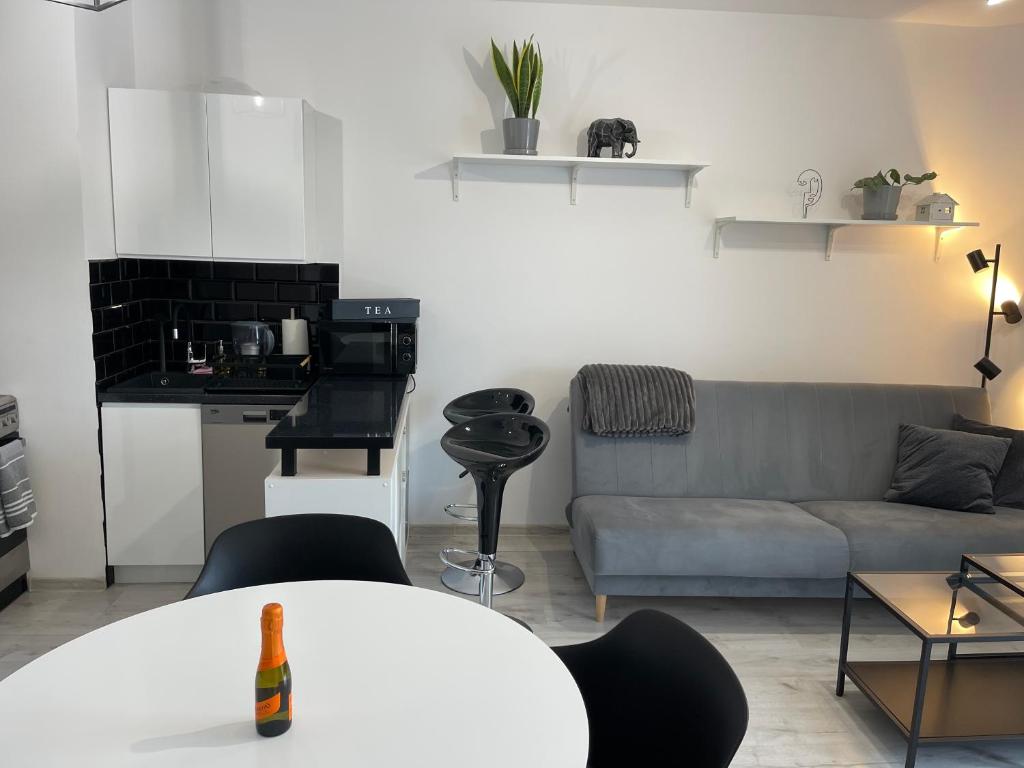a living room with a couch and a table at Modern Box Apartment in Gdynia