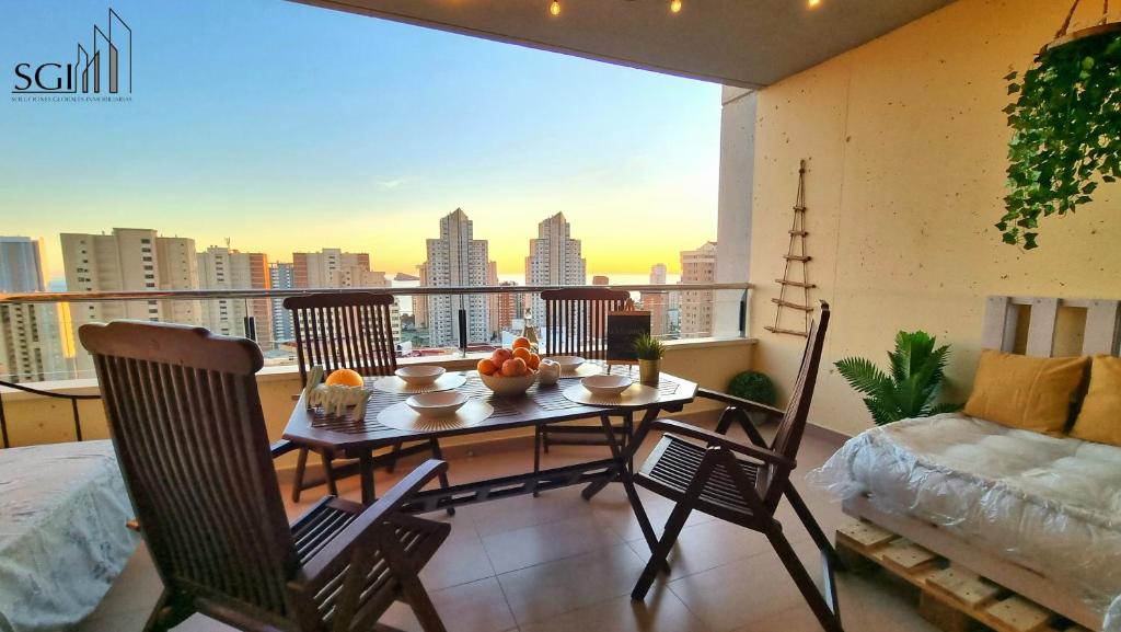 a room with a table and chairs on a balcony at SUNSET Chill Out- Torres D' Oboe in Benidorm