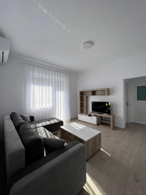 a living room with a couch and a coffee table at Apartment in Peja city center in Peje