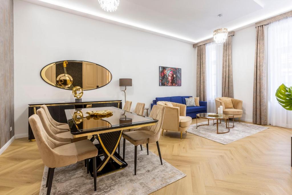 a living room with a table and chairs and a couch at Luxurious Bajcsy Residence next to the Basilica in Budapest