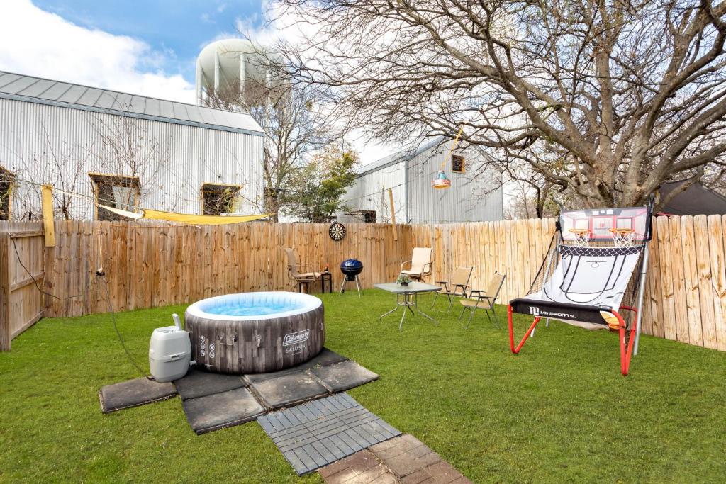 a backyard with a hot tub and a fence at SA Family Home 3BR 3BA Home w 12 Arcade Games & HotTub- 5mins to Airport w Private Garage in San Antonio