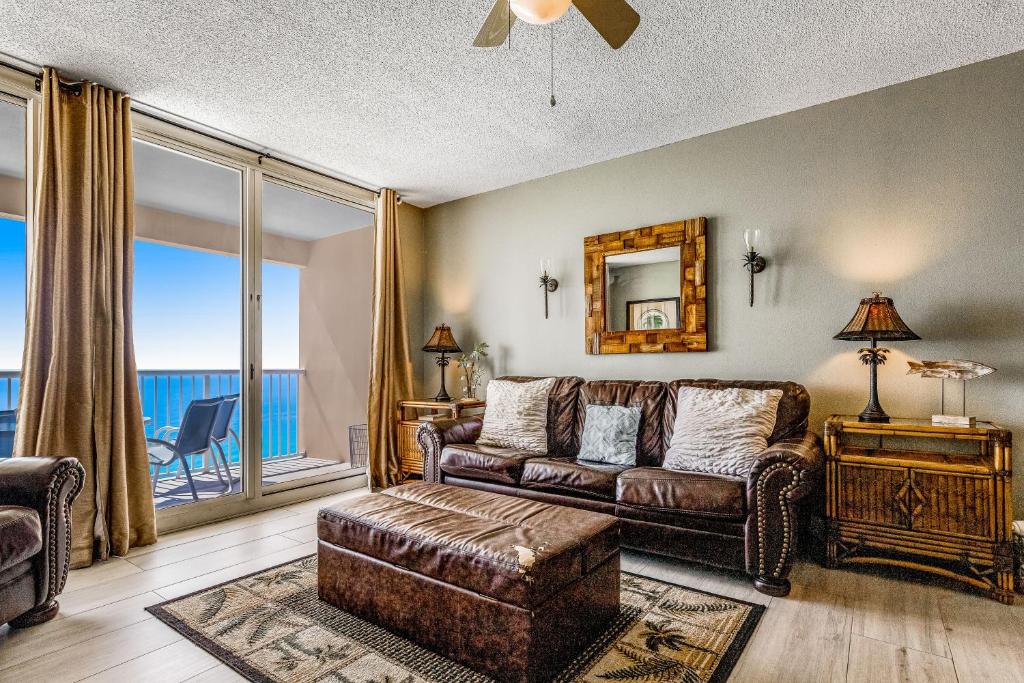 a living room with a couch and a window at Majestic Beach Resort Tower 2- 1903 in Panama City Beach