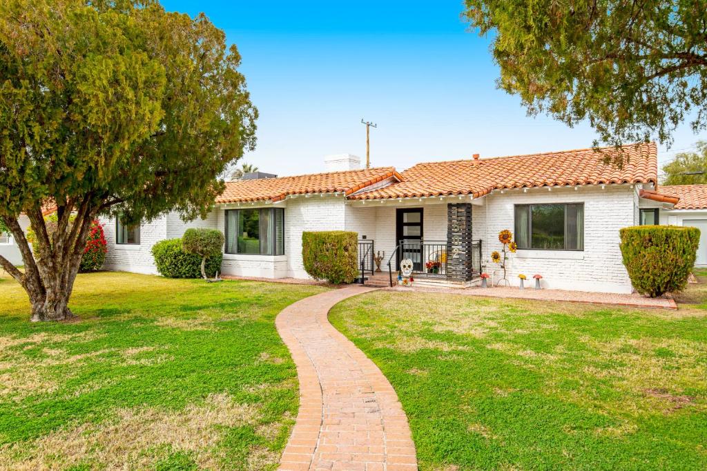 a house with a brick walkway in front of a yard at Encanto Dreams in Phoenix