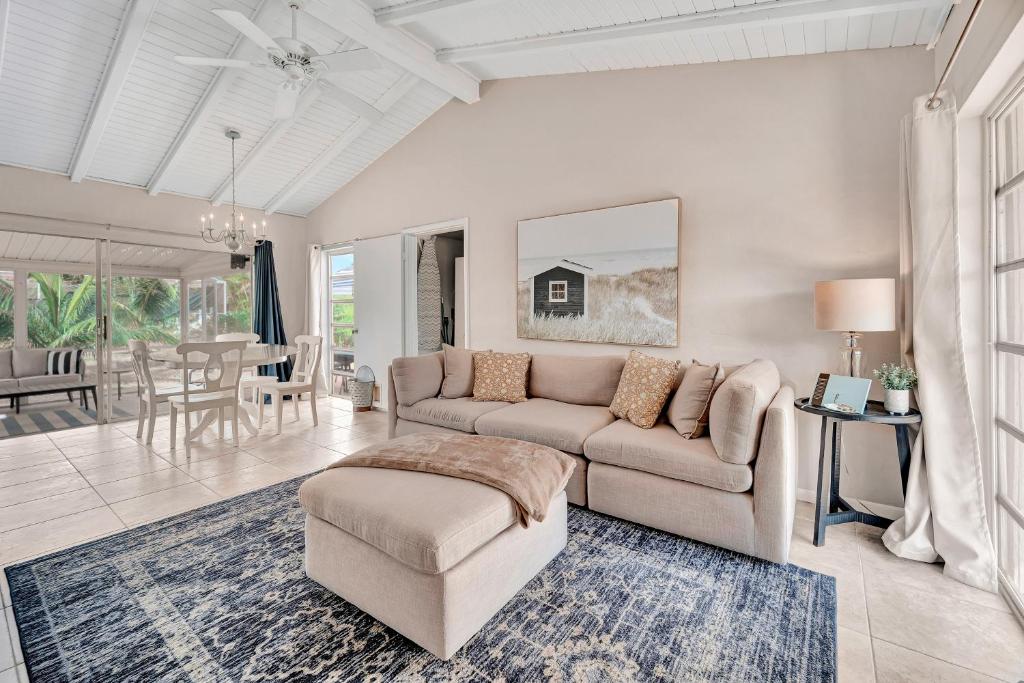 a living room with a couch and a table at Sunny Sanctuary in Marco Island