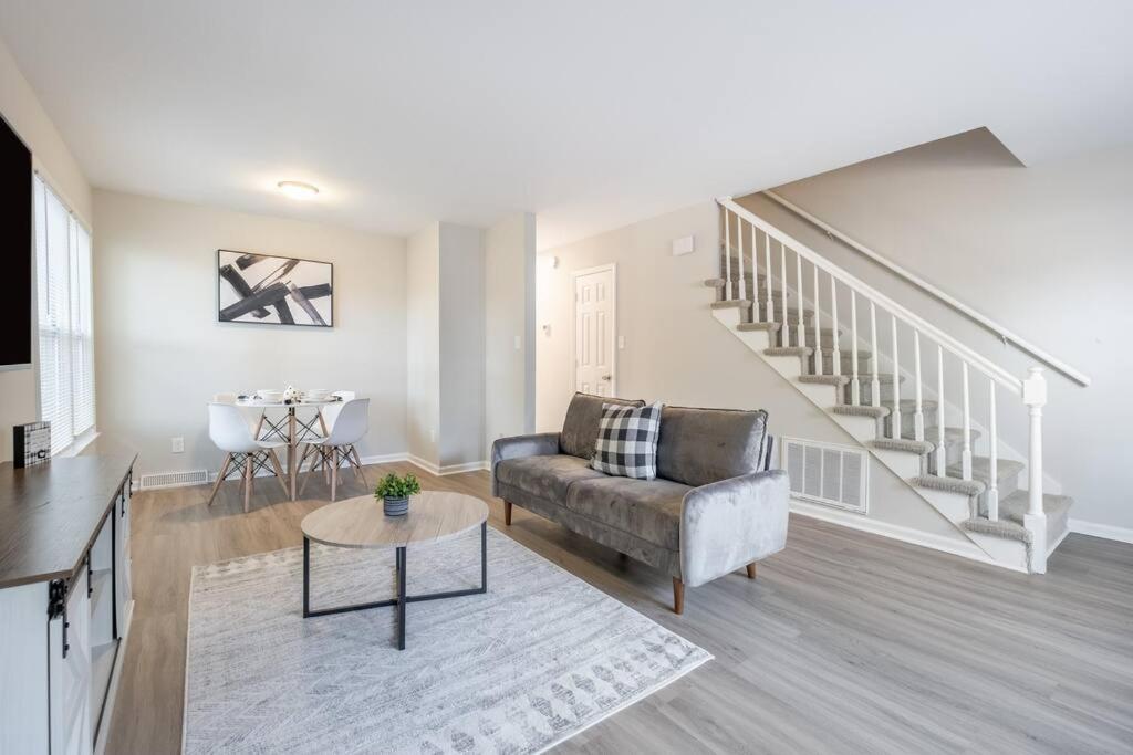 a living room with a couch and a table at Stunning SouthPark/Cotswold Home in Charlotte