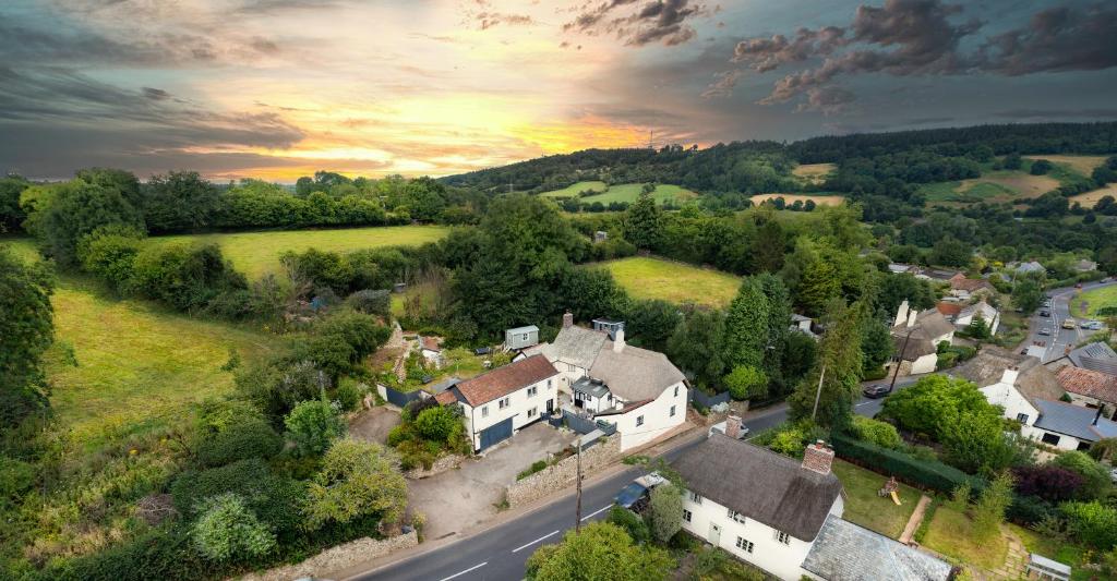 an aerial view of a small village with a house at Rose Farm in Honiton