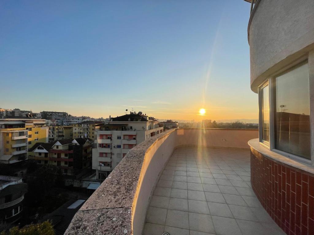 a view of the sunset from the balcony of a building at B&B - Private Rooms in Tirana