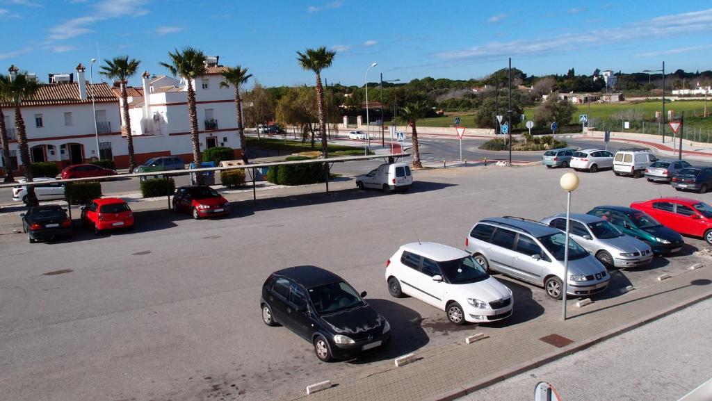 a group of cars parked in a parking lot at Hotel Catalán Puerto Real in Puerto Real