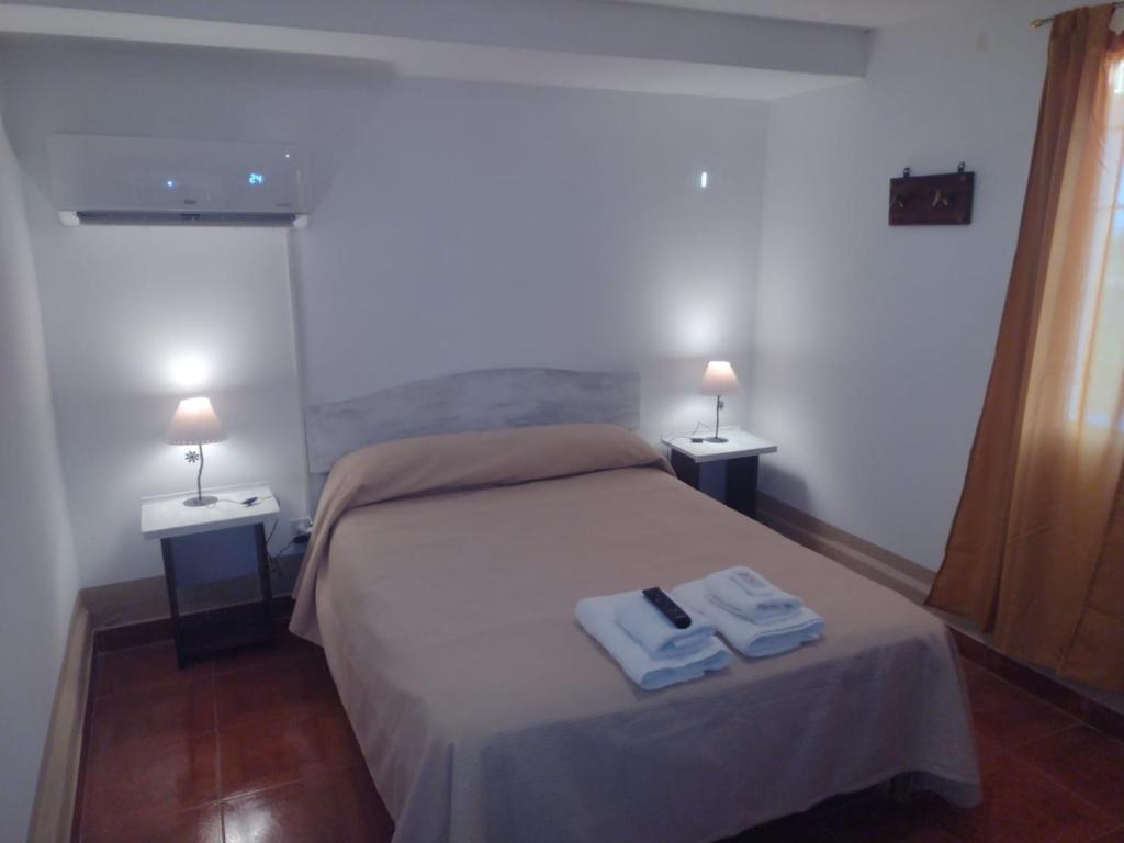 1 dormitorio con 1 cama con 2 toallas en Flor de Cardón en La Rioja