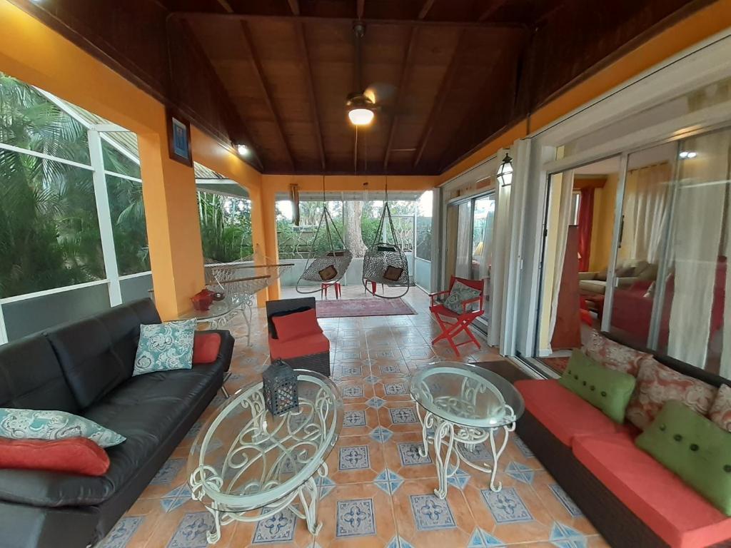 a living room with a couch and a table and chairs at Gorgeous Lakeview Front Lake Osborne in Lake Worth