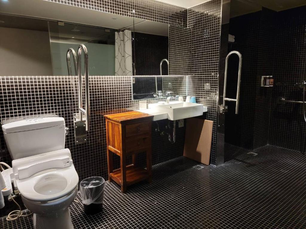 a bathroom with a toilet and a sink at Simple + Hotel in Taipei