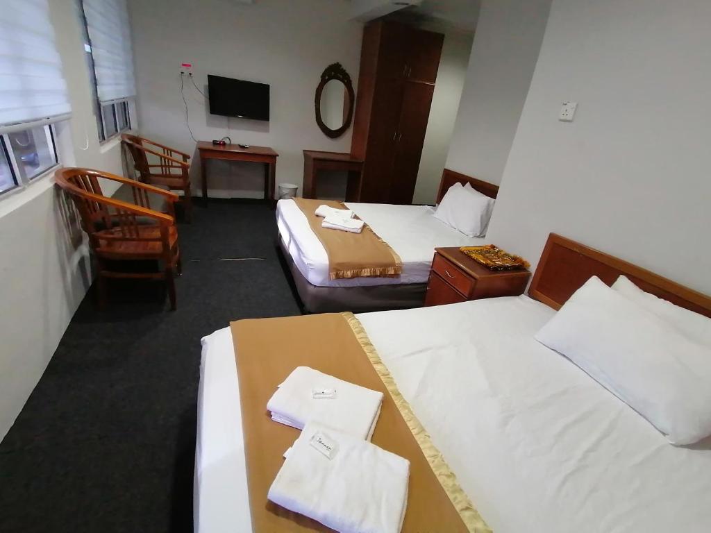 Postel nebo postele na pokoji v ubytování Mi Hotel 2 Dungun