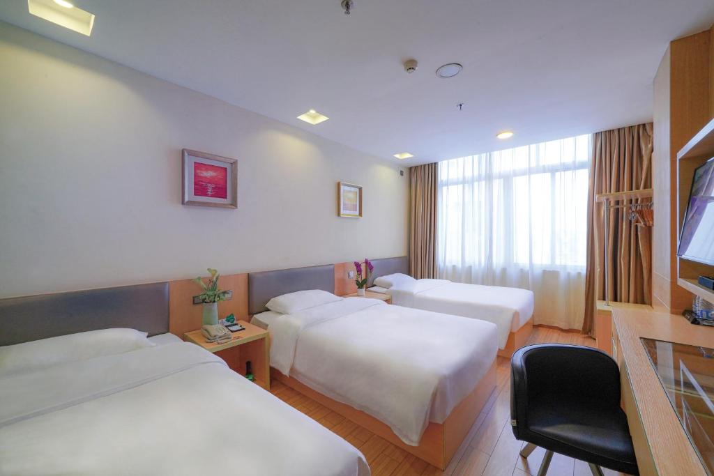 Postel nebo postele na pokoji v ubytování Guangdong Baiyun City Hotel