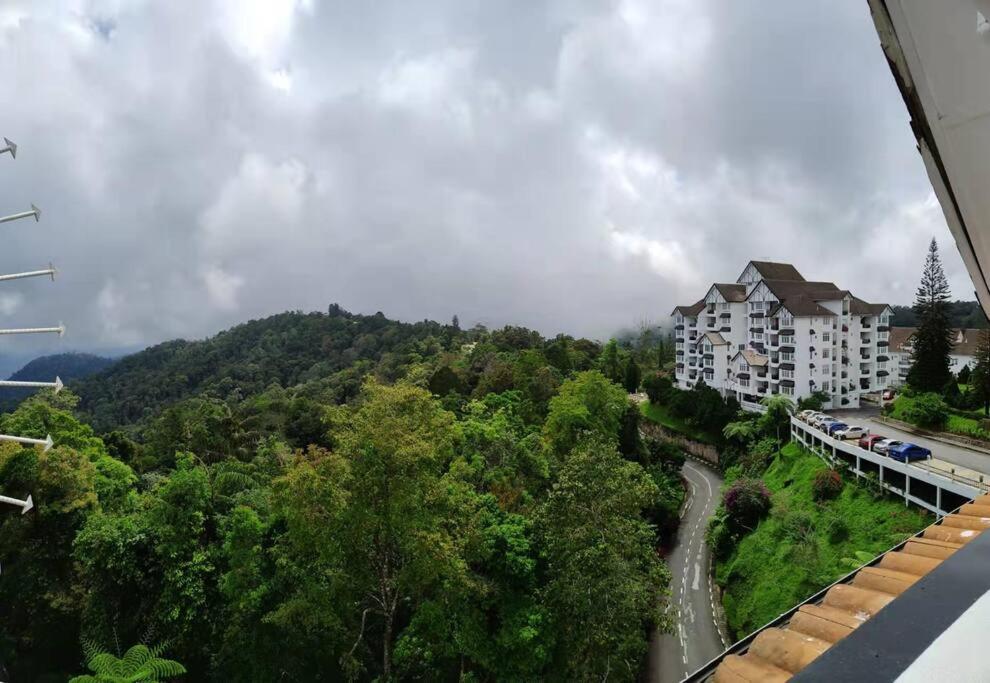 a view of a building on a hill with trees at Fraser Hill Silverpart Resort B2-6-1 Forest View High Floor No Lift in Bukit Fraser